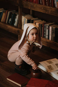 Toddler baby girl in funny hat with ears having fun