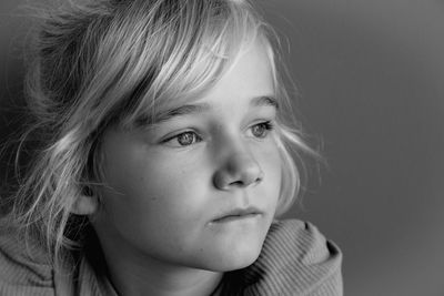 Close-up portrait of cute girl looking away