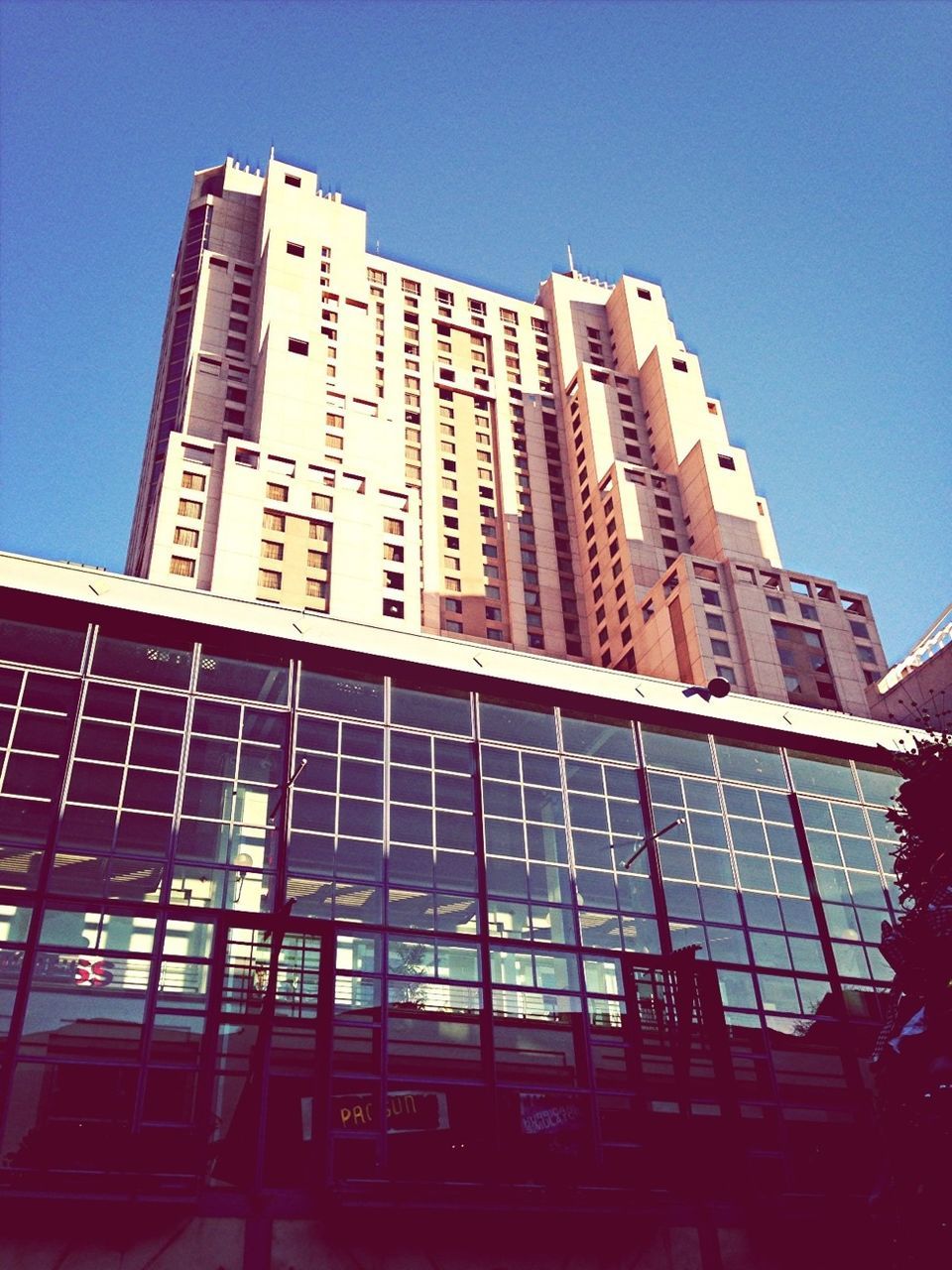 architecture, building exterior, built structure, low angle view, clear sky, city, modern, office building, building, tall - high, skyscraper, tower, glass - material, window, blue, reflection, day, development, outdoors, city life