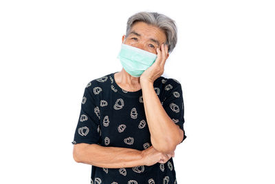 Portrait of man wearing mask against white background