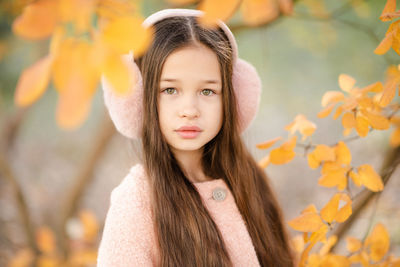 Cute kid girl 10-12 year old with long blonde hair wear headband earphones with yellow autumn 