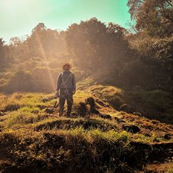 Man standing by tree on land