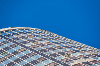 Low angle view of modern building against clear blue sky