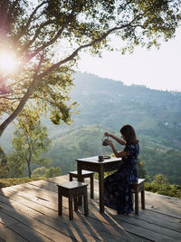 Woman drinking tea in garden