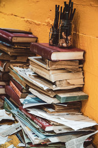 Stack of book on table against wall