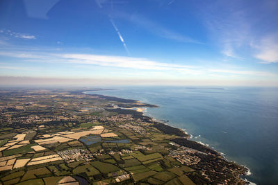 High angle view of buildings by sea against sky