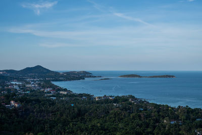 Scenic view of sea by buildings against sky