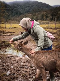 Man with umbrella on field