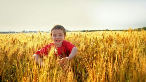 Portrait of smiling girl standing in wheat field