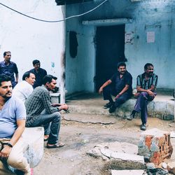 People sitting on abandoned building