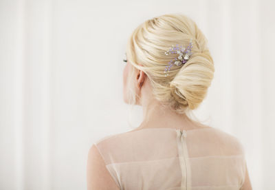 Rear view of bride against curtain