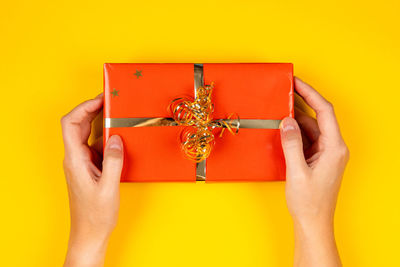 Close-up of woman hand holding yellow box