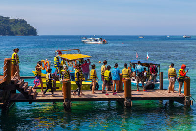 People on beach against sky