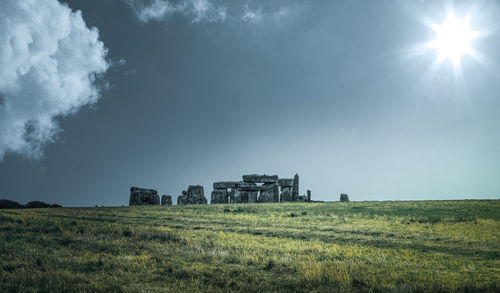 Built structure on field against sky