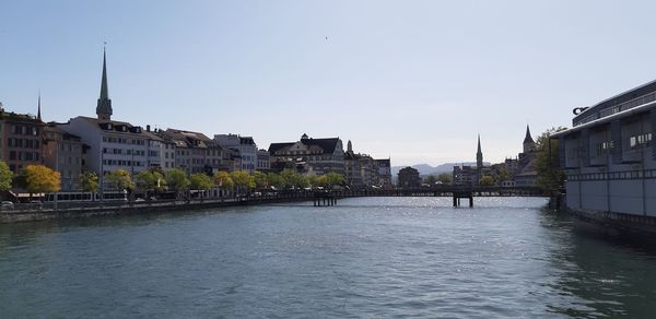 Buildings in city against clear sky