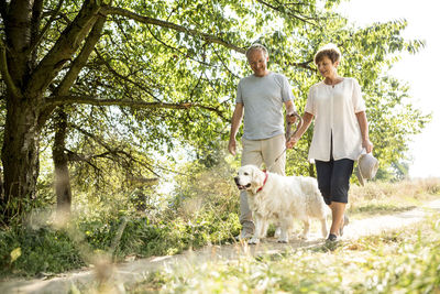 Senior couple going walkies with dog