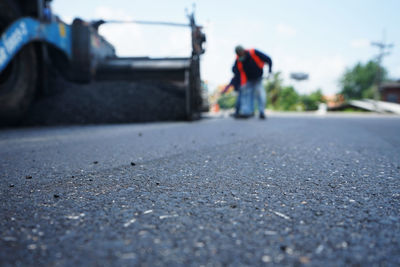 Surface level of road against sky in city