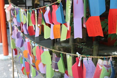 Multi colored fortune papers hanging on ropes