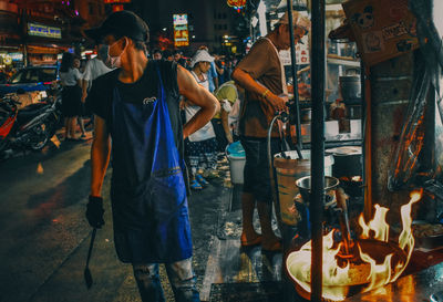 People working on street in city