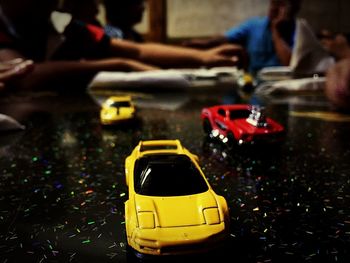 Close-up of hand holding yellow toy car