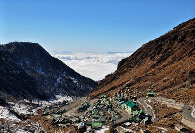 Aerial view of mountain range against blue sky