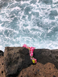 Used snacks placed on the rocks by the beach.