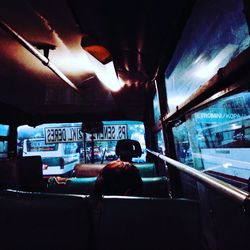 Rear view of man working in bus