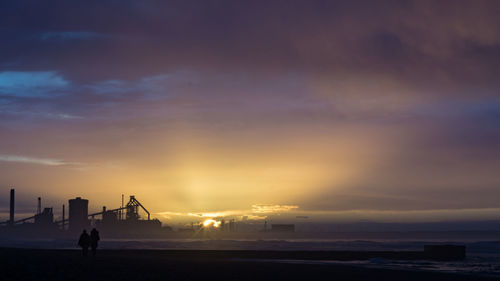 Scenic view of beach against sky during sunset