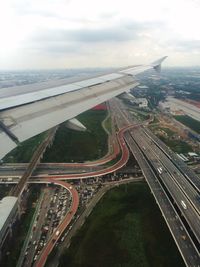 Cropped image of airplane flying over cityscape