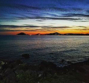 Scenic view of sea against sky at sunset