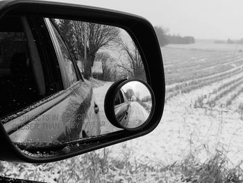 Reflection falling on car side-view mirror