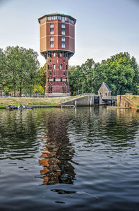 Converted watertower reflecting in canal on a summer evening