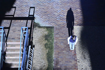 Rear view of woman walking on street