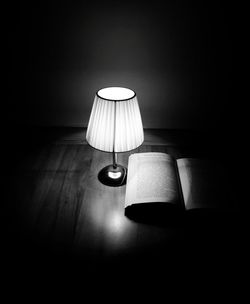 Close-up of electric lamp on table at home