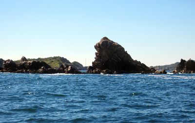 Scenic view of sea against clear blue sky