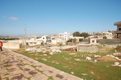 Buildings in city against clear blue sky