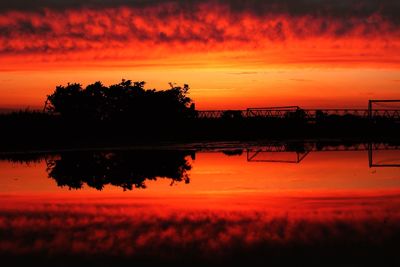 Scenic view of lake against romantic sky at sunset