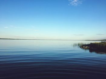 Scenic view of lake against blue sky