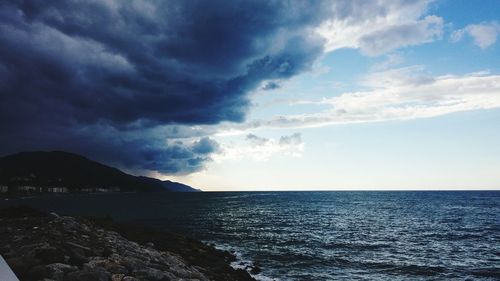 Scenic view of sea against cloudy sky