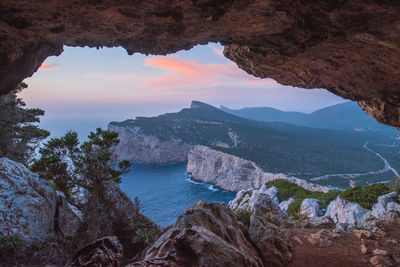 Scenic view of rock by seascape 