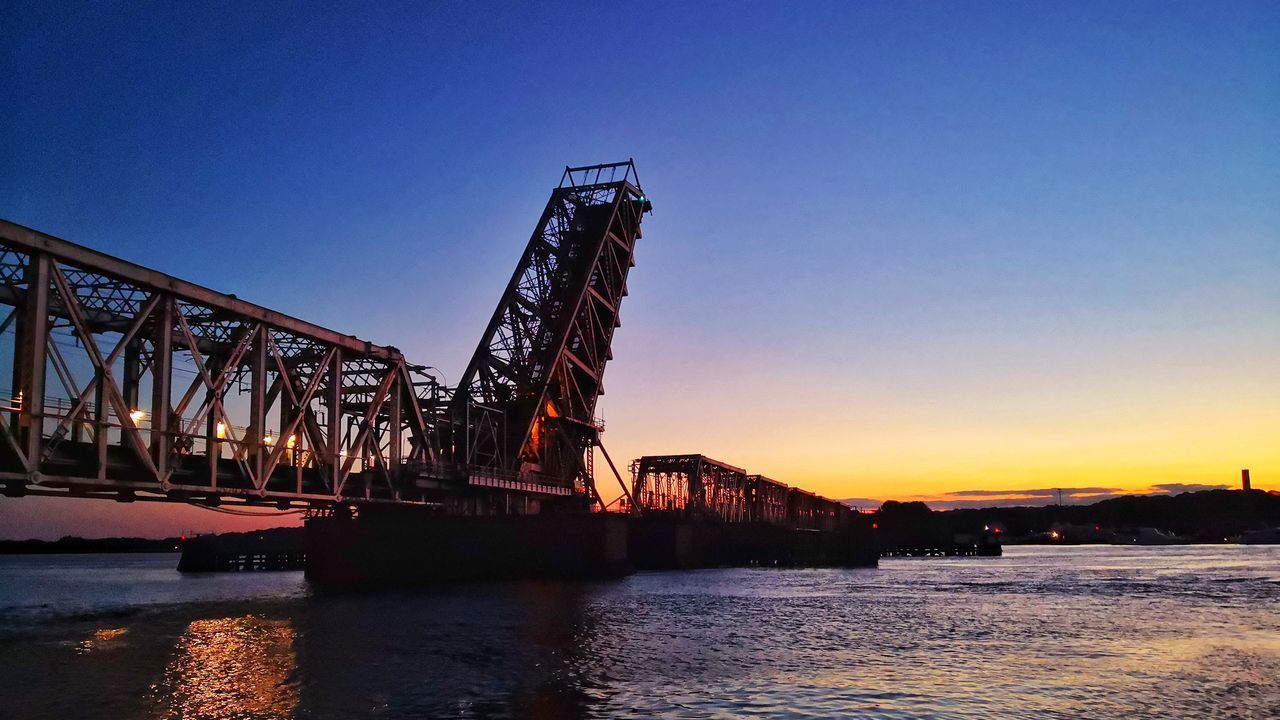 BRIDGE OVER RIVER AGAINST CLEAR BLUE SKY