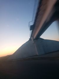 Low angle view of mountain against clear sky during sunset