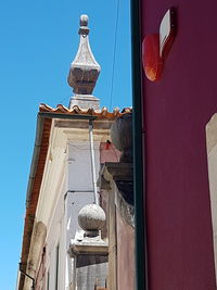 Low angle view of cross against clear blue sky