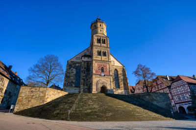 Low angle view of historic building against clear blue sky