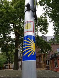 Low angle view of sign board on street against sky