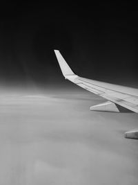 Close-up of airplane wing against sky