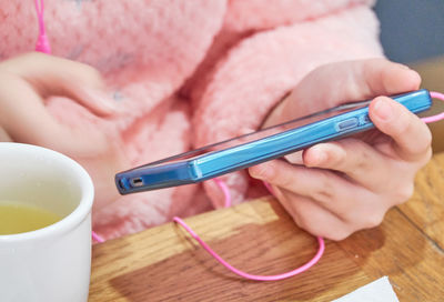 Midsection of woman using mobile phone