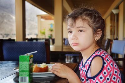 Portrait of boy looking away in plate on table