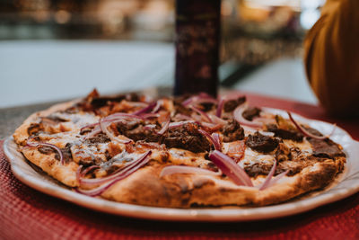 Close-up of pizza in plate on table