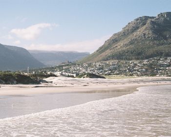 Scenic view of sea and mountains against sky